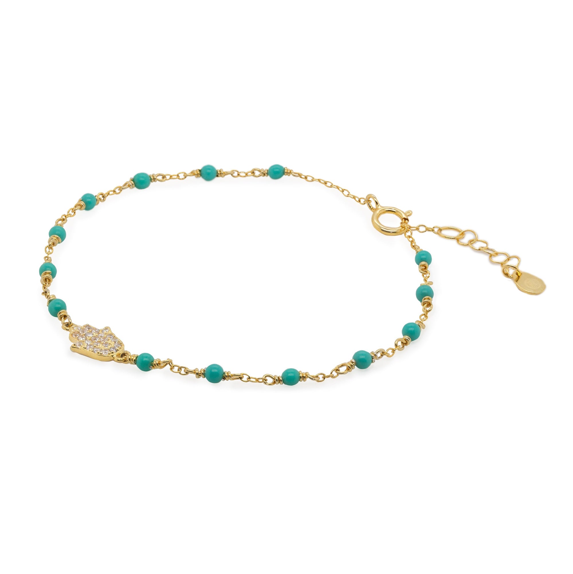 Gold bracelet with turquoise beads on a white background