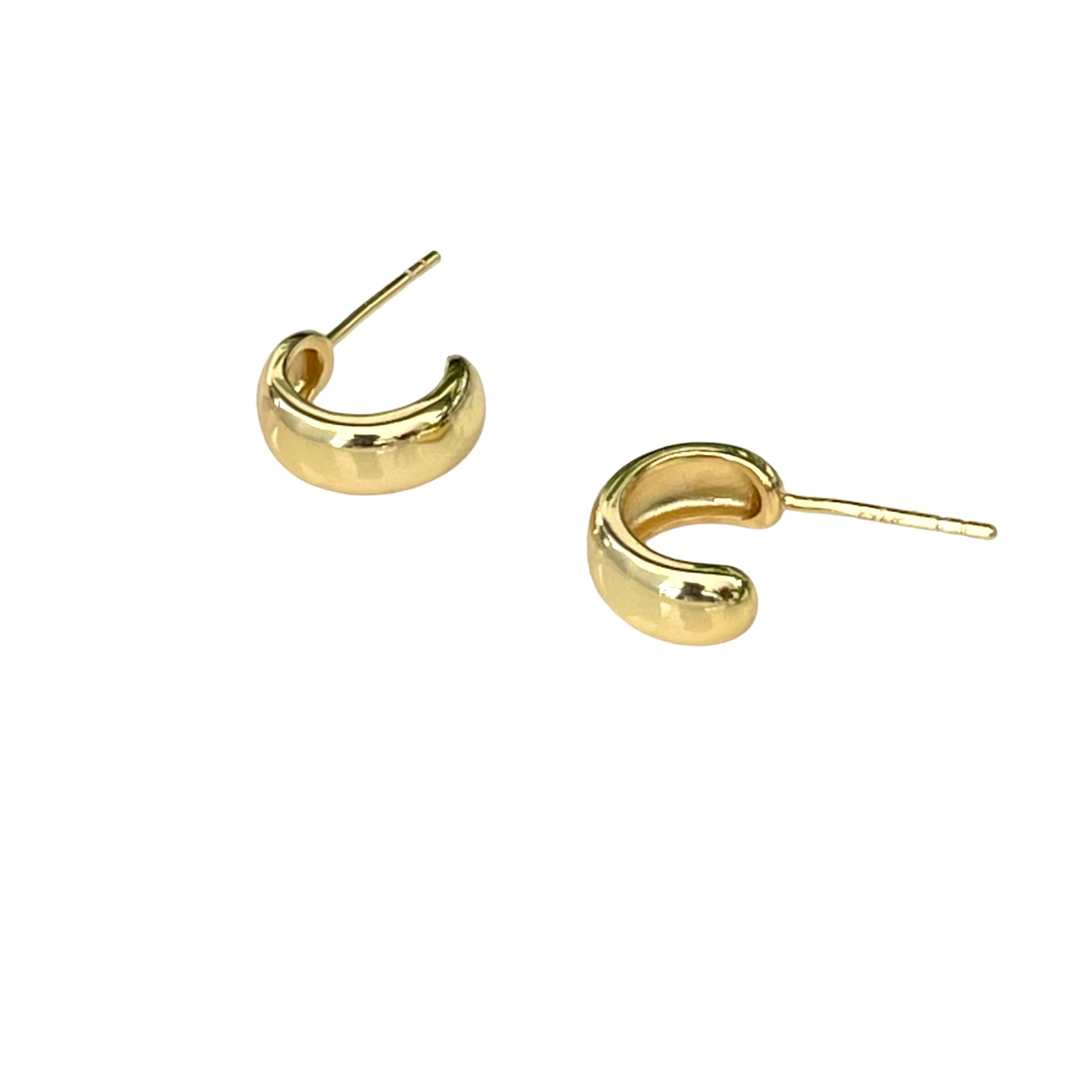 A pair of gold-plated huggie hoop earrings on a white background.